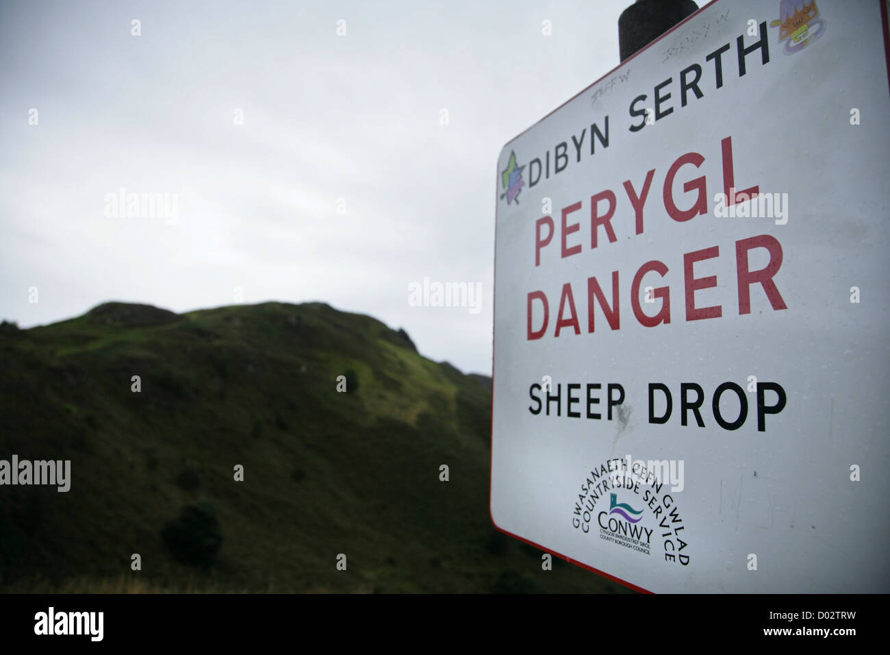 Sheer Drop warning sign changed to 'Sheep Drop' on the summit of Conwy Mountain, North Wales. Stock Photo