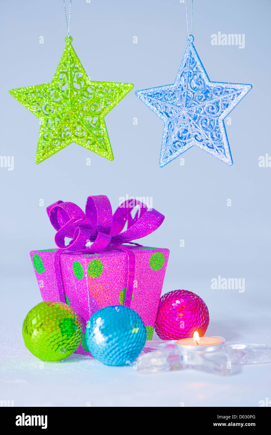 Party time. Colorful party decoration. Purple gift box with big bow and green spots. Stock Photo