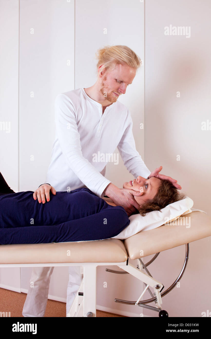 Practitioner or physiotherapist manipulating a patient's head and neck