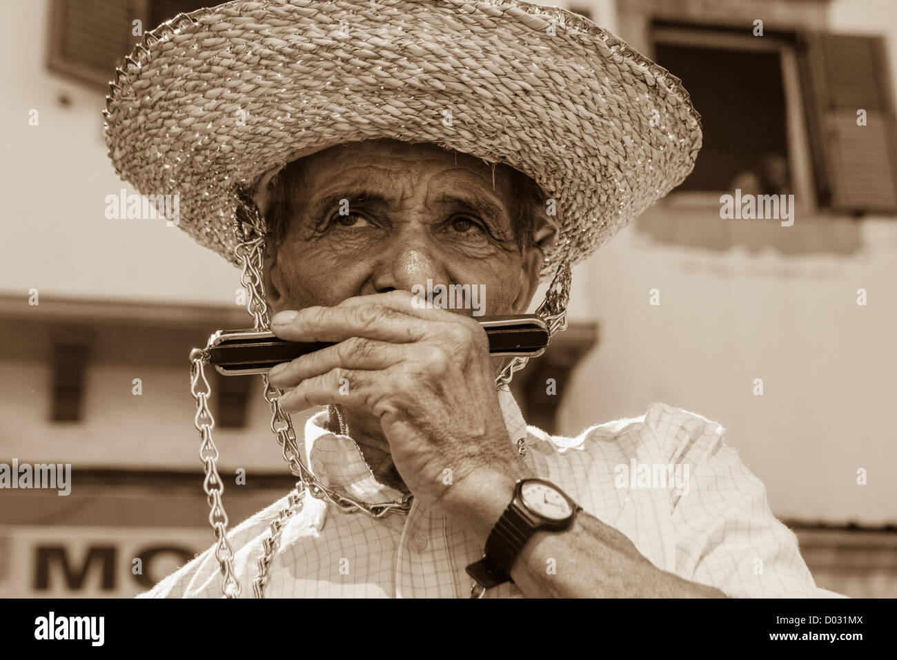Man playing mouth organ at El Pino fiesta in Teror on Gran Canaria, Canary Islands, Spain Stock Photo