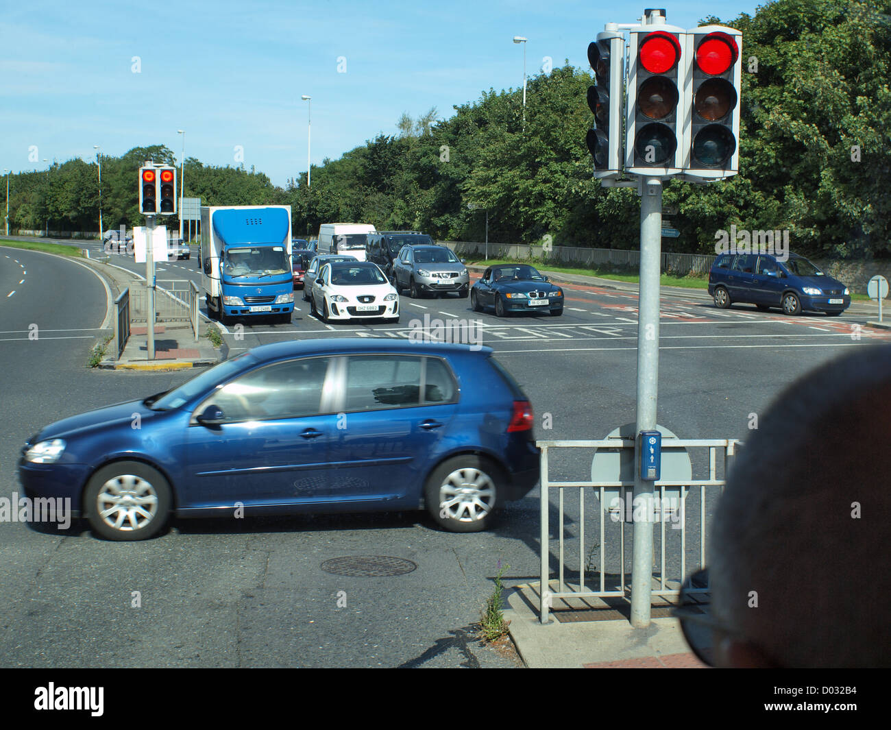 Suburban traffic flow, stationary at a traffic light road intersection in Galway City in the West of Ireland. Stock Photo