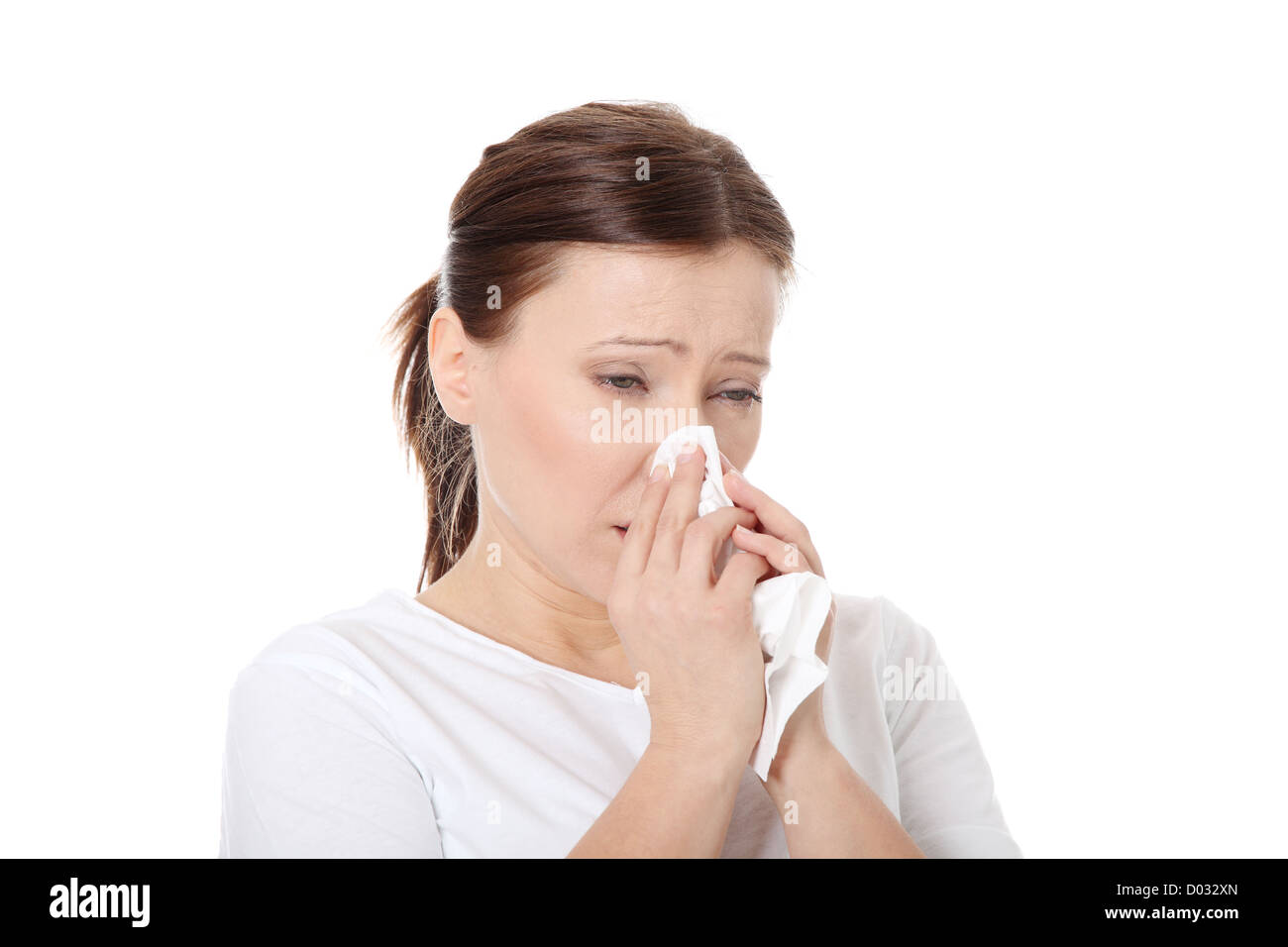 35-40 year old woman with tissue, heaving allergy or cold. Isolated on white background Stock Photo