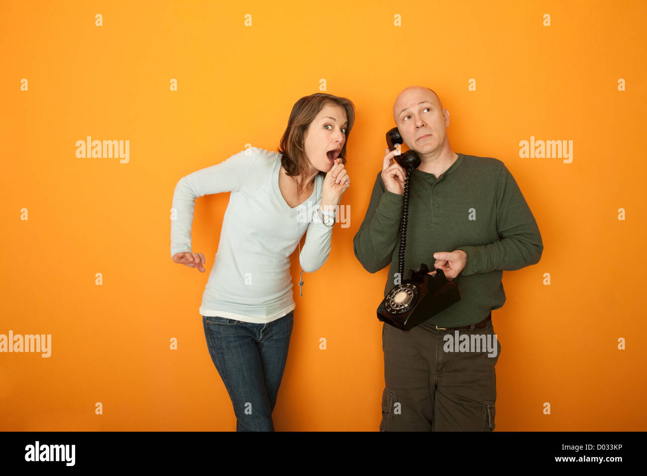 Surprised woman with man on telephone conversation Stock Photo - Alamy