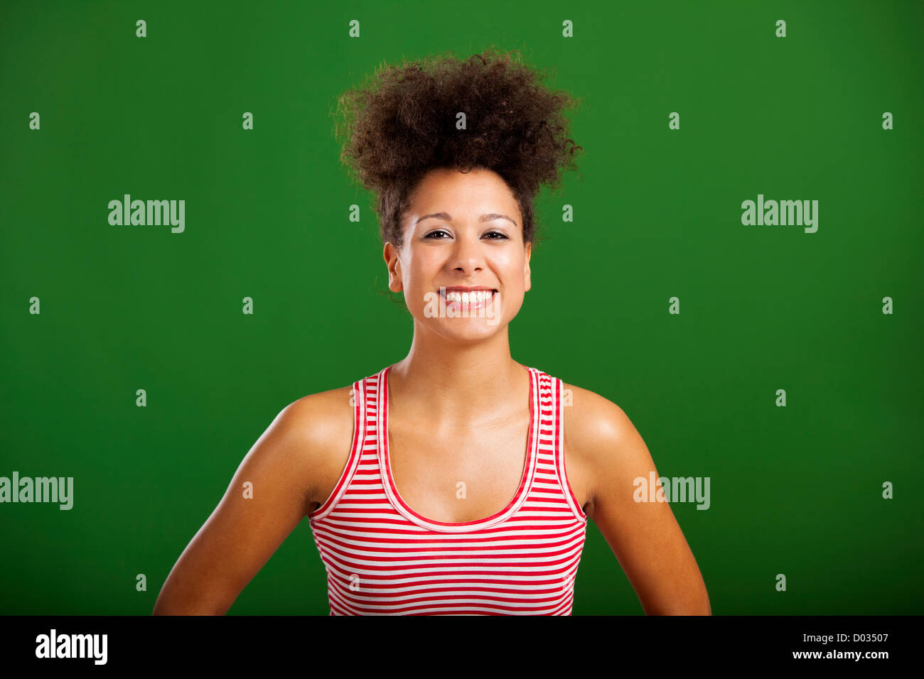 Beautiful African woman laughing over a green background Stock Photo ...