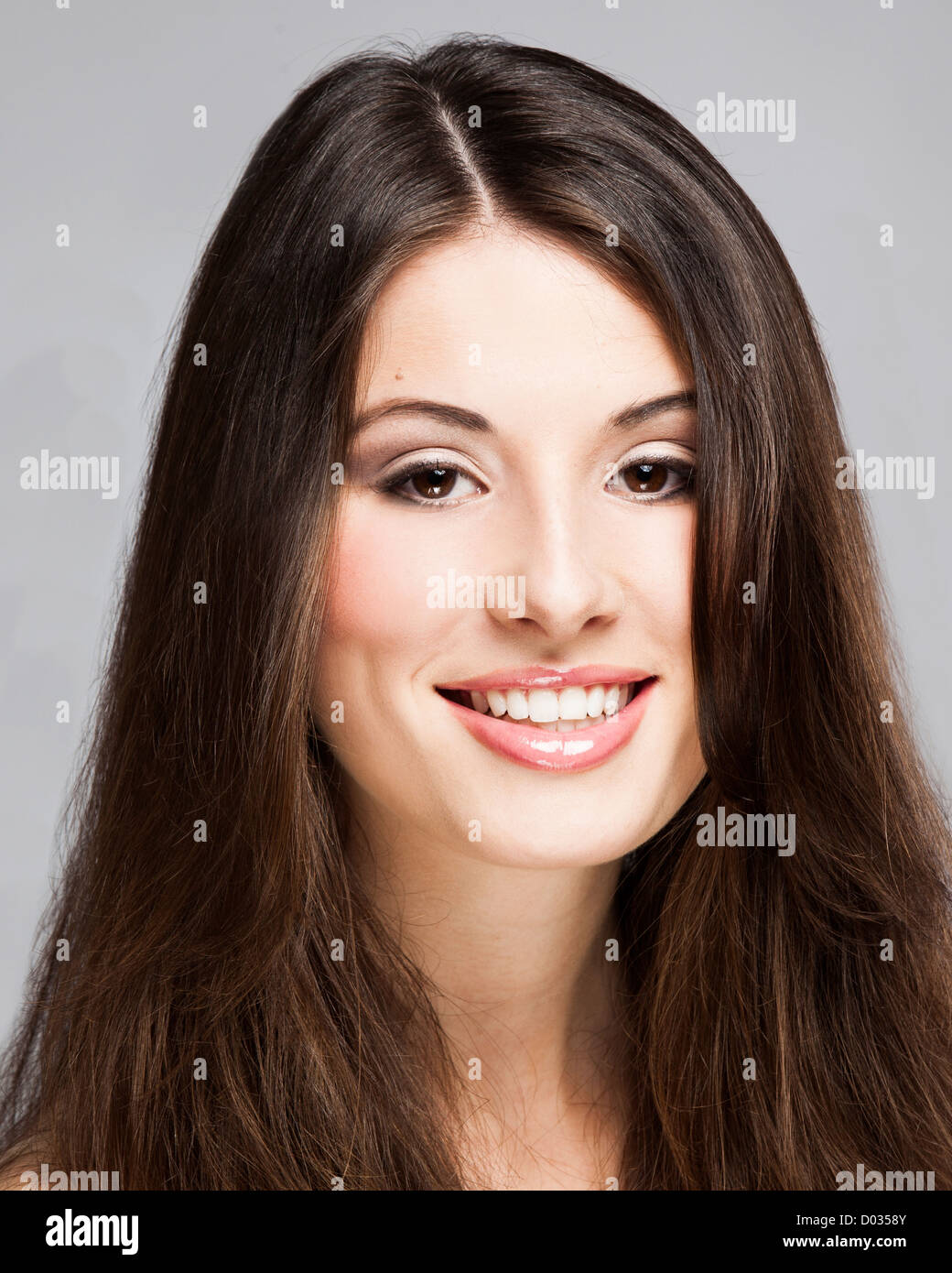 Studio portrait of a beautiful young woman smiling Stock Photo - Alamy