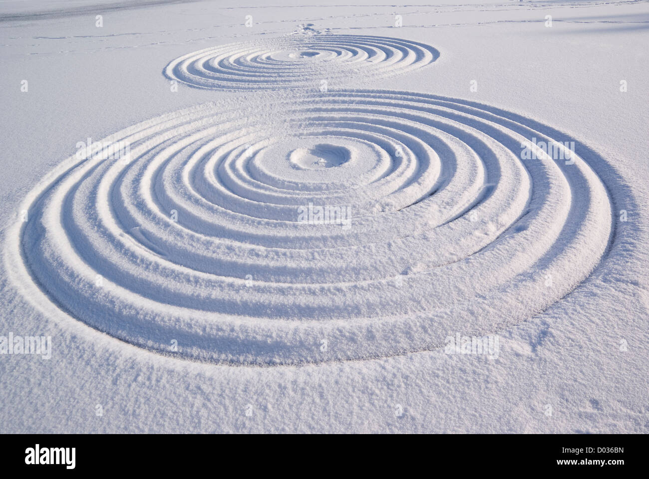 two drawn different circles of size on snow Stock Photo