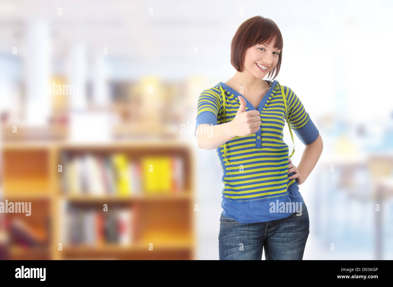 Young student girl with thumb up Stock Photo - Alamy
