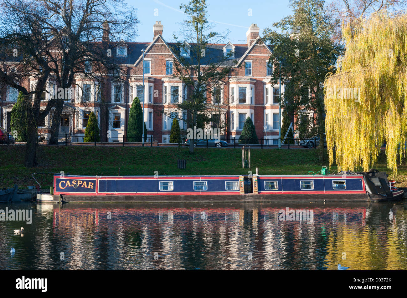 House boats and barges moored on the River Cam at Jesus Green Cambridge