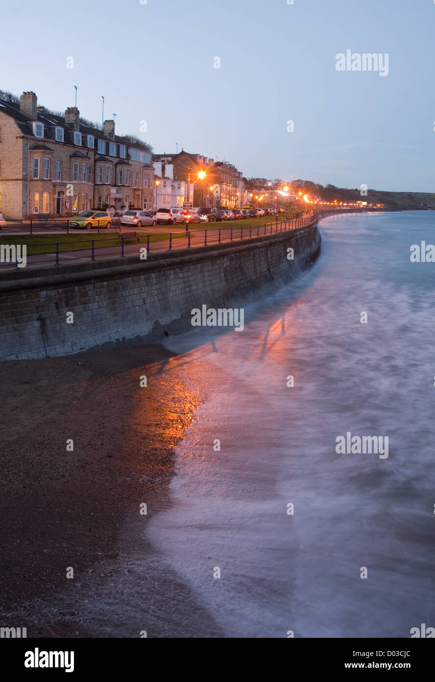 Filey Bay and seafront looking up the promenade as day turns to night. Stock Photo