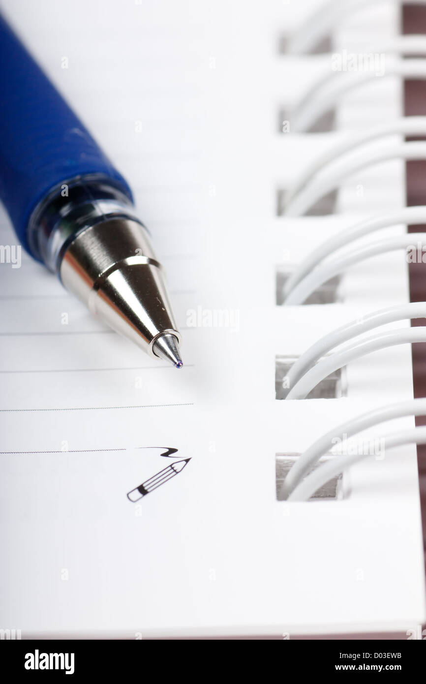 Macro view of blank spiral notebook and ball pen Stock Photo