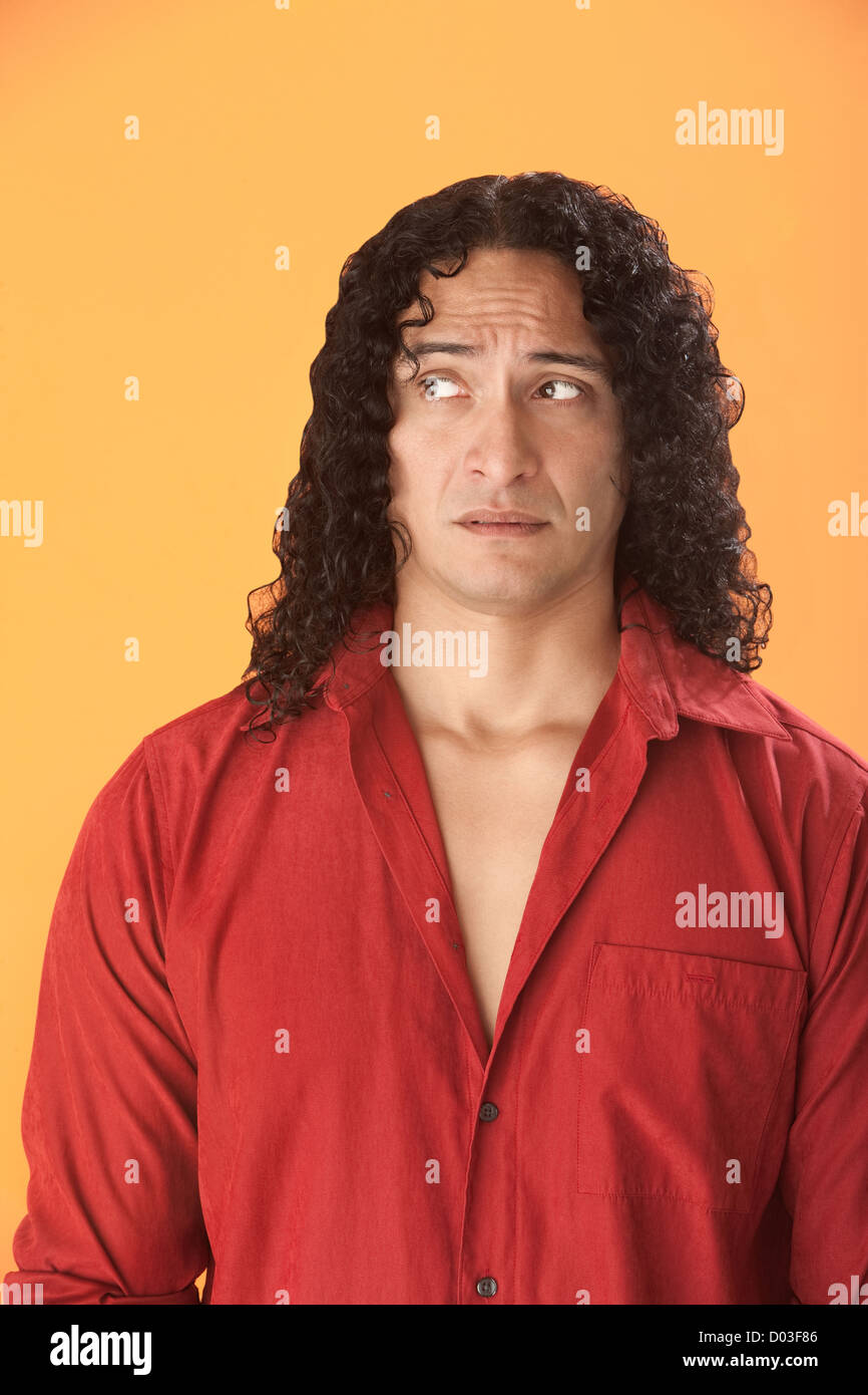 Well-built Native American man on an orange background looks over Stock ...