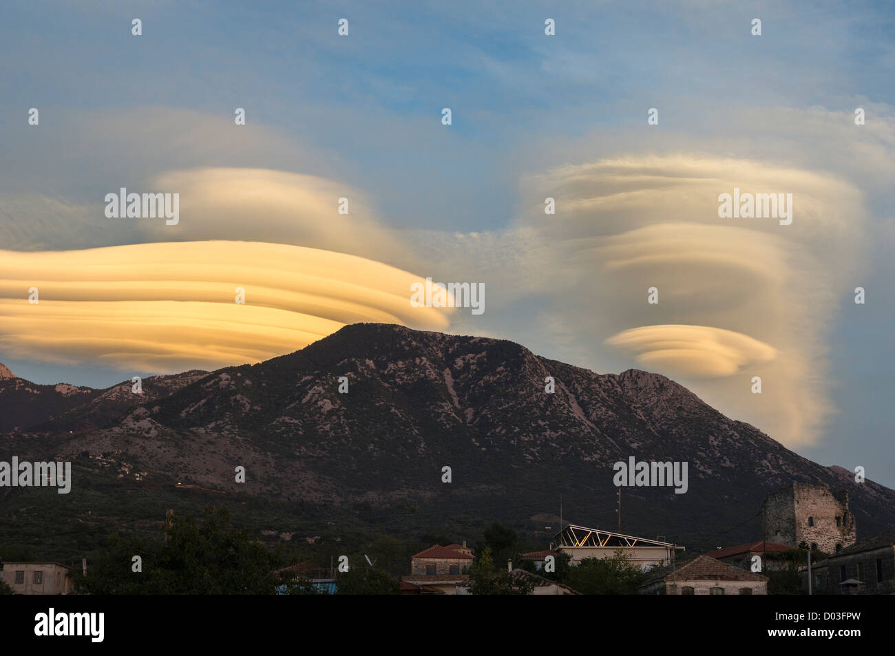 Lenticular clouds forming at sunset over the Taygetus mountains, in the Outer Mani, Peloponnese, Greece. Stock Photo