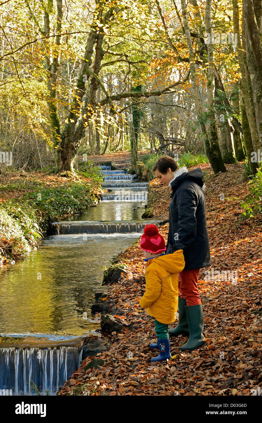 A Mum and little boy by the red river in tehidy country park, camborne, cornwall, uk Stock Photo