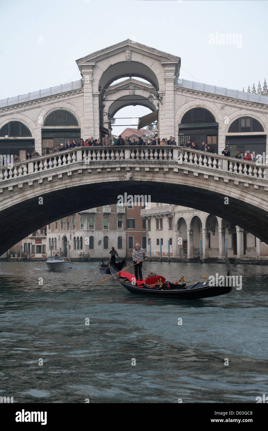 The Rialto Bridge Gondolas and gondoliers on the Grand Canal of Venice Italy in Autumn Stock Photo