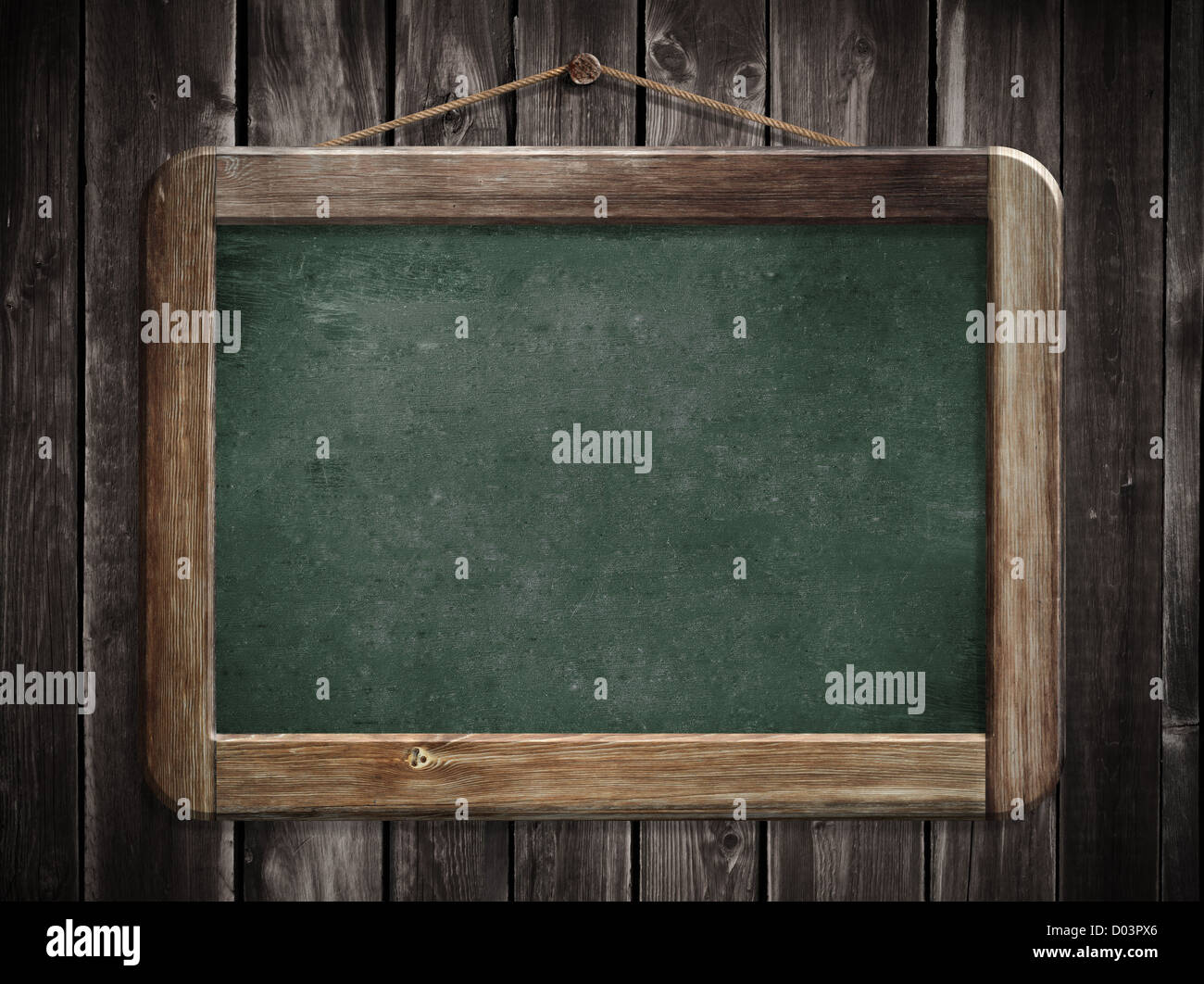 Aged green blackboard hanging on wooden wall as a background for your message Stock Photo