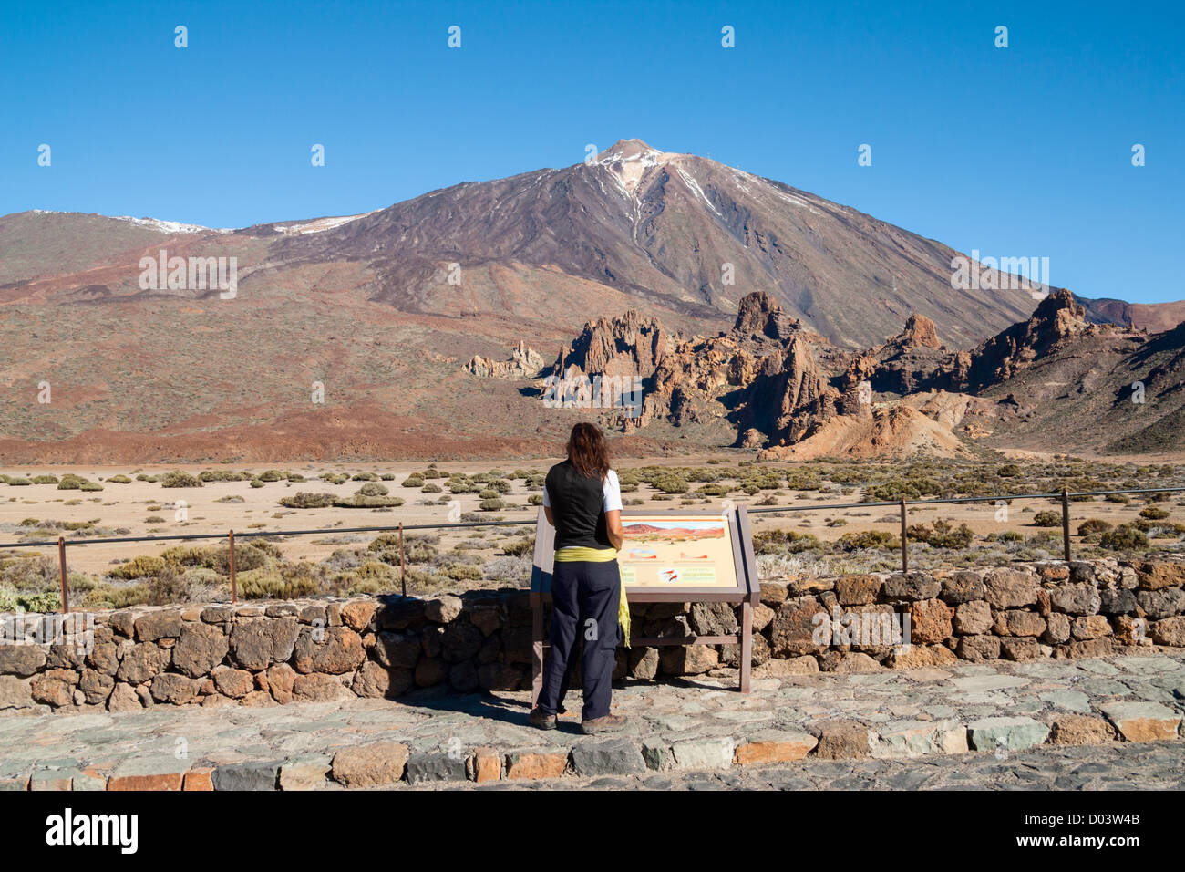 Female hiker reading information board at Llano de Ucanca in Parque Nacional del Teide on Tenerife, Canary Islands, Spain Stock Photo