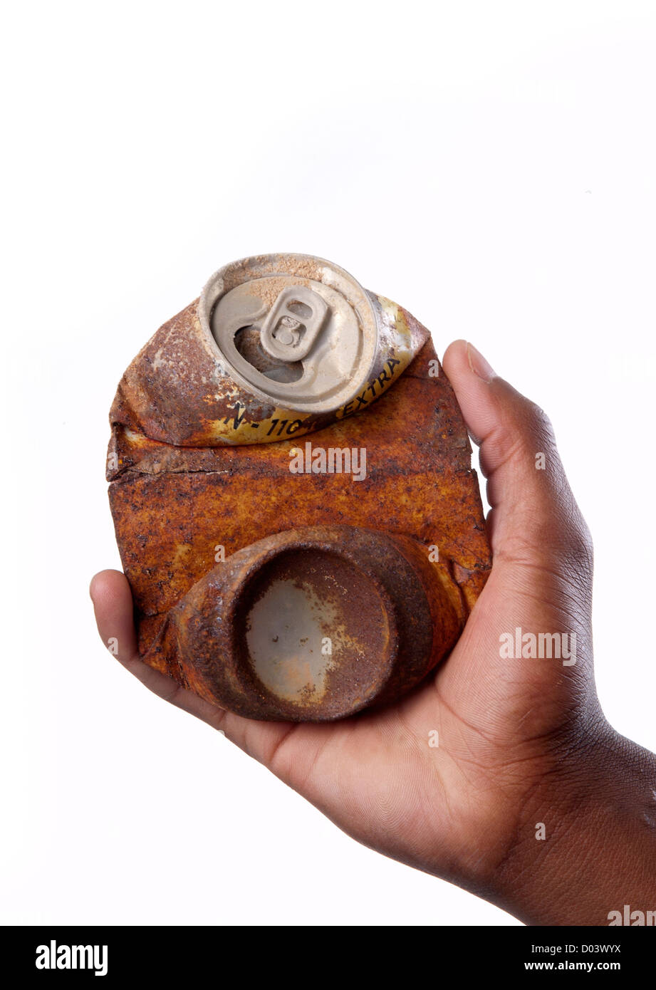 hand holding rusty flattened or crushed soft drink soda can. Stock Photo