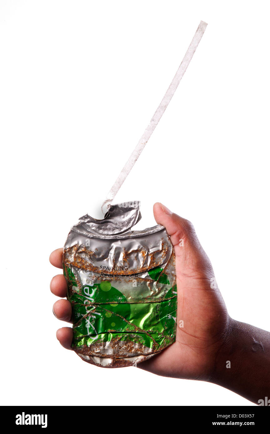 hand holding rusty flattened or crushed Appletizer soft drink soda can. Stock Photo