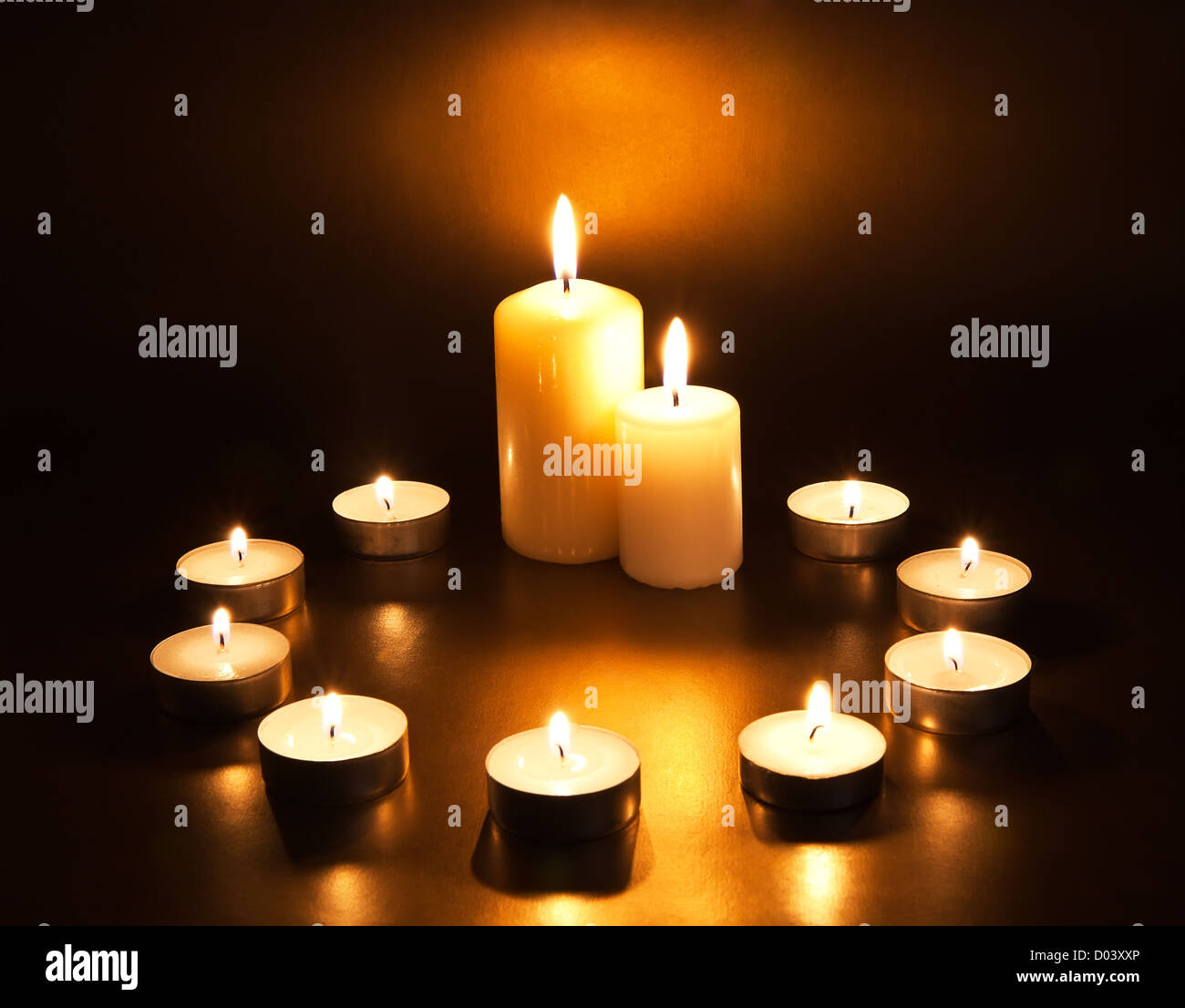 Burning candles on dark background Stock Photo - Alamy