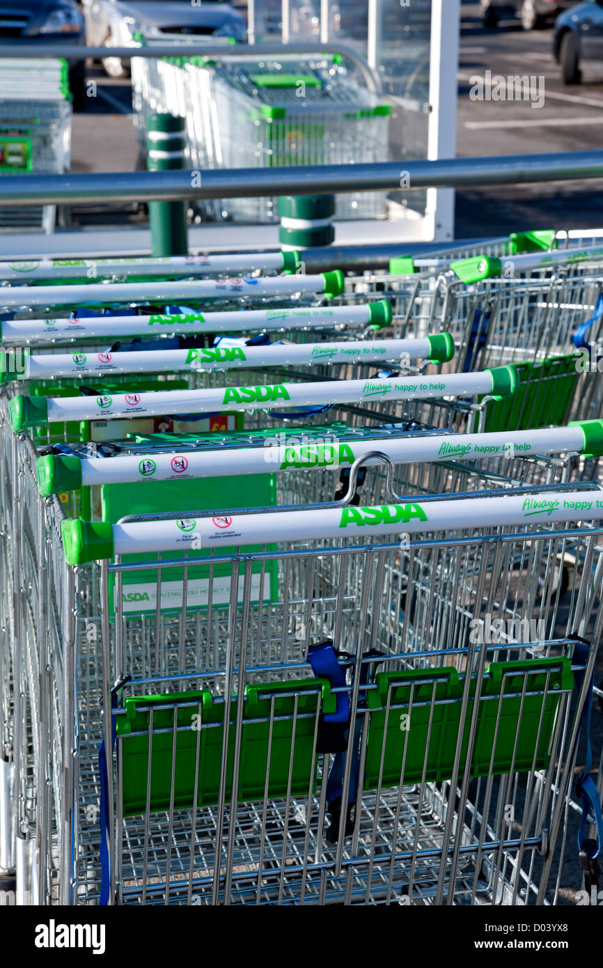 Close up of row of ASDA supermarket shopping trollies trolley trolleys outside shop store England UK United Kingdom GB Great Britain Stock Photo