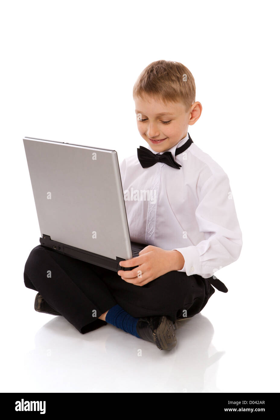 Six years Boy holding laptop isolated on white Stock Photo