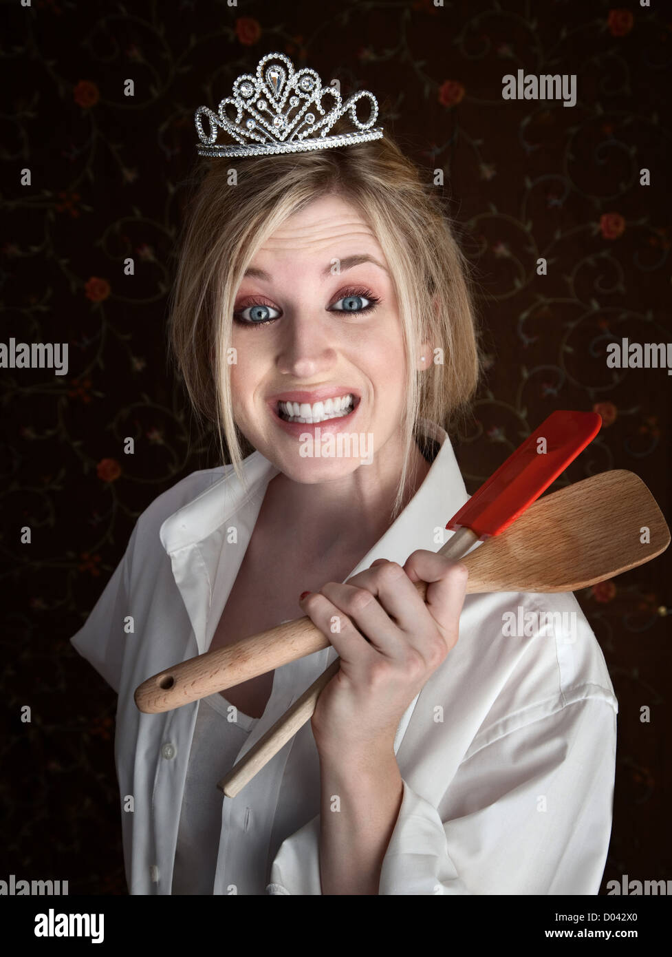 Grinning Caucasian lady holding spatulas Stock Photo Alamy