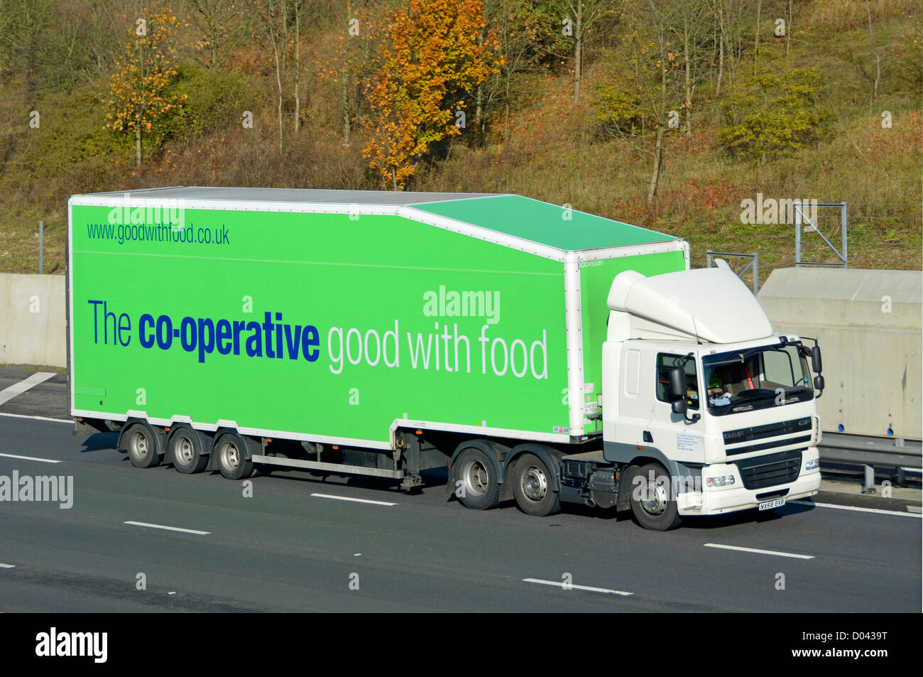 Co op transportation logistics food supply chain via supermarket food store delivery trailer & hgv lorry truck driving along English UK M25 motorway Stock Photo
