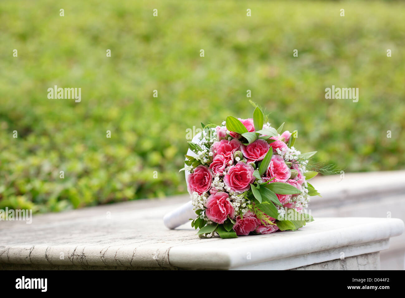 Beautiful bridal bouquet over green Stock Photo