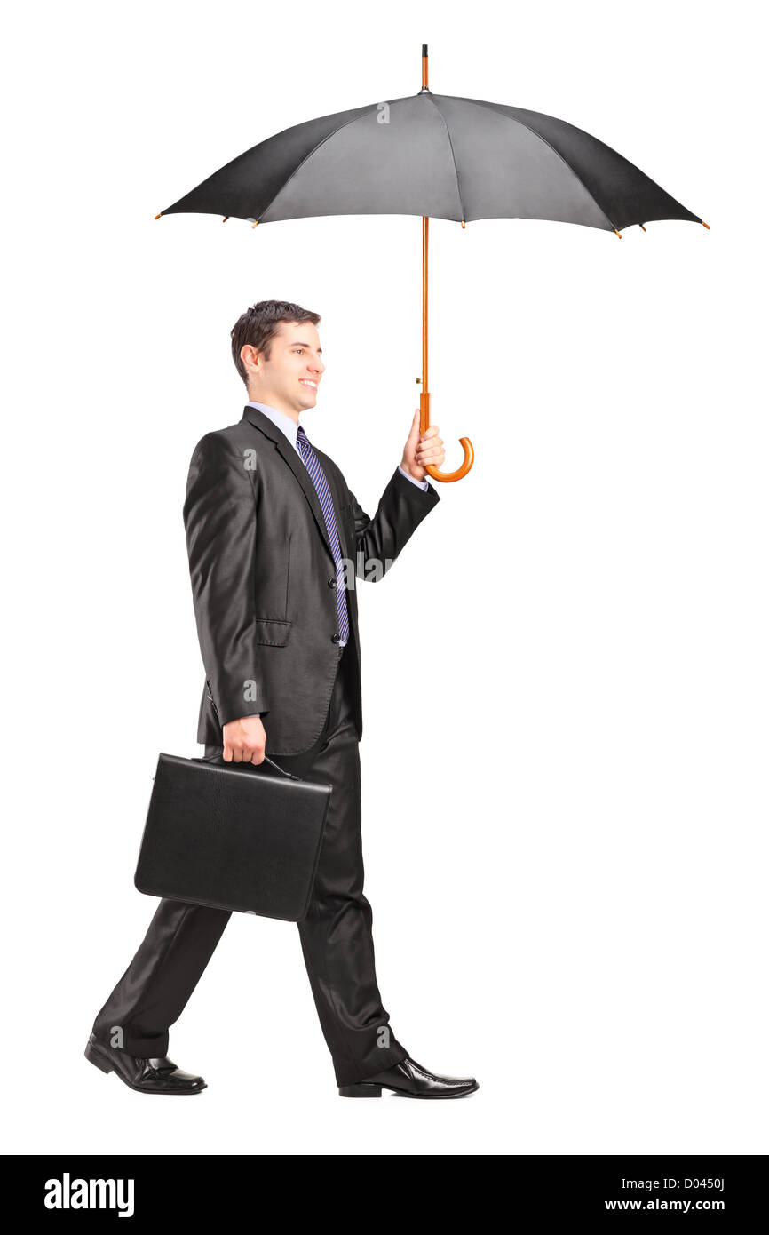 Full length portrait of a man holding an umbrella and briefcase isolated on white background Stock Photo