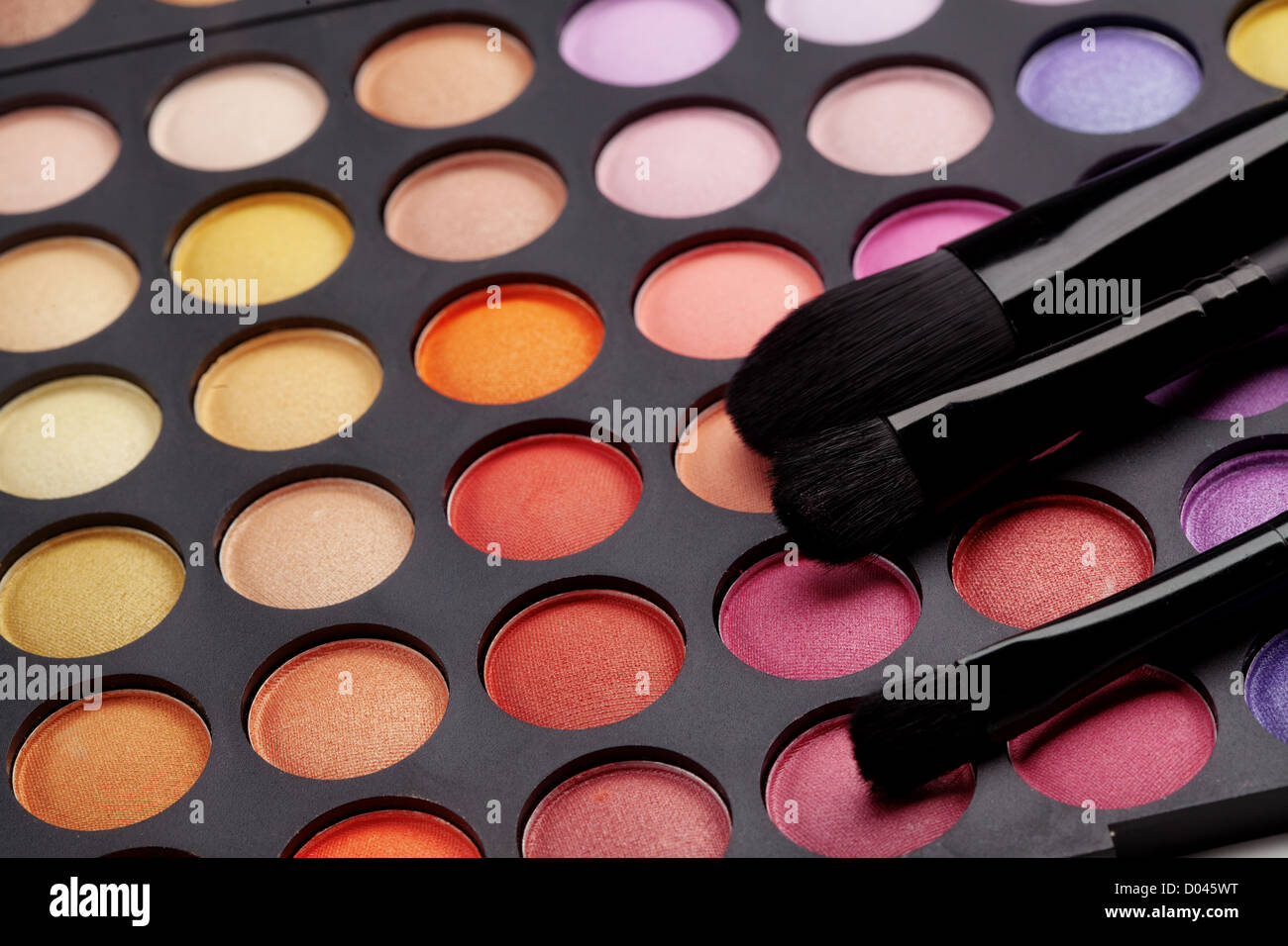 Make-up colorful eyeshadow palette with makeup brushes on it Stock Photo