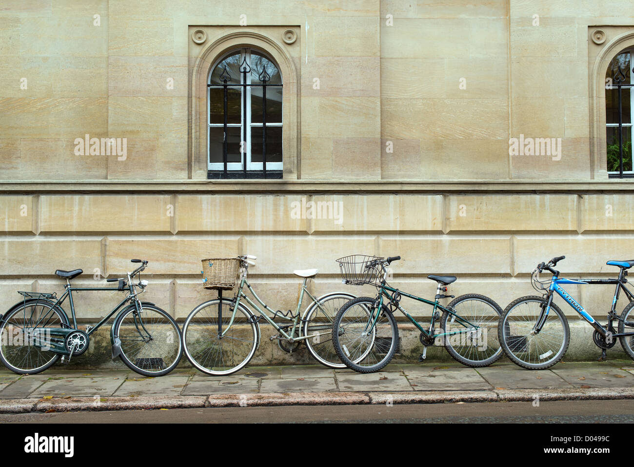 Bicycles used by students at the university of Cambridge, England, are parked in a line Stock