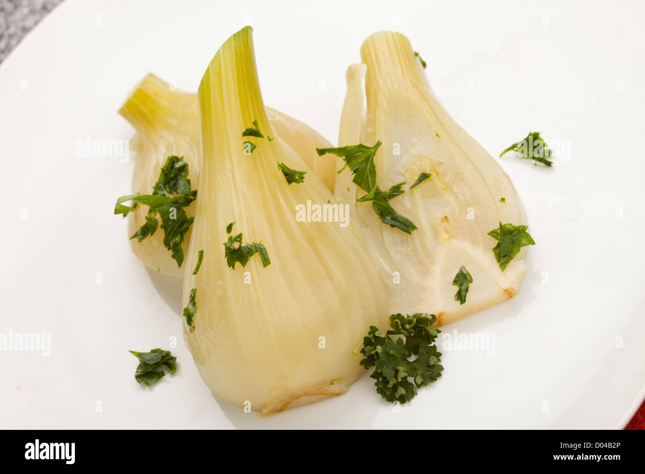 photo of cooked fennel with parley on a glass table Stock Photo Alamy