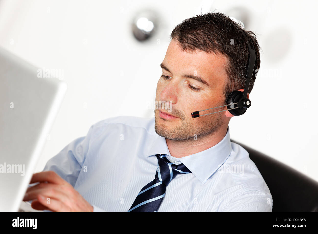 man in office with headset and computer Stock Photo - Alamy