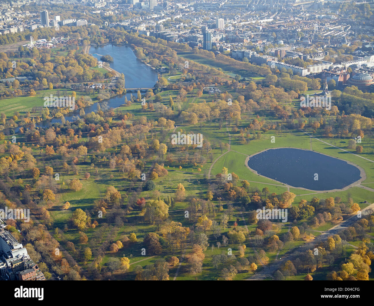 Autumnal colours in Hyde Park London, from the air, showing the Round Pond and The Serpentine behind Stock Photo