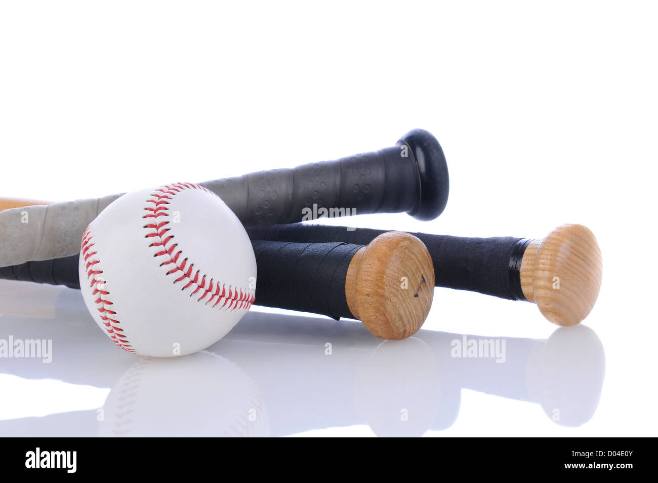 Closeup of a baseball and three bats on a white background with reflection, horizontal format. Stock Photo