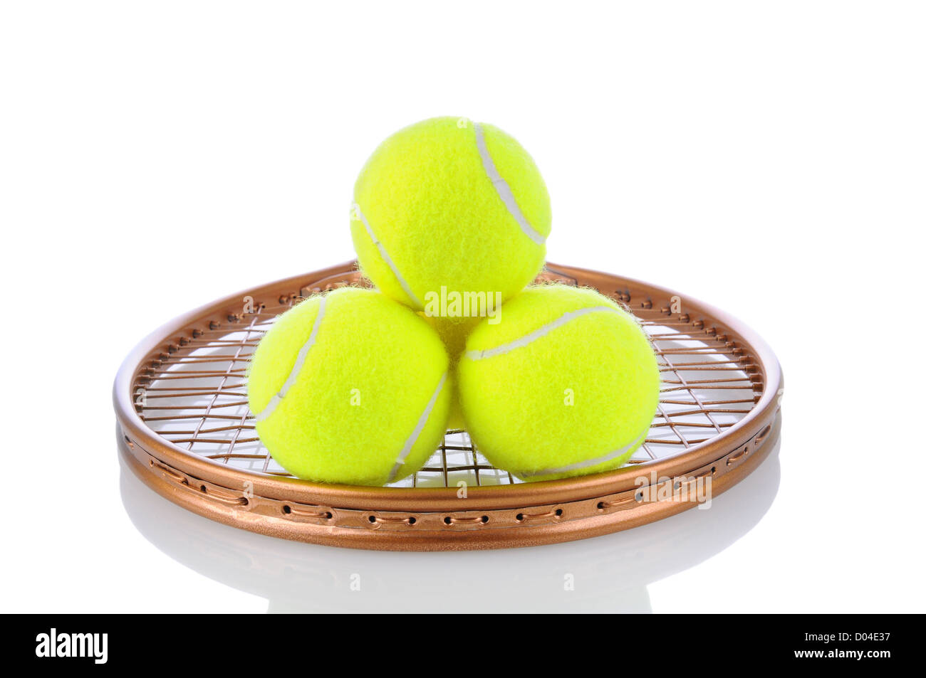 Closeup of a stack of tennis balls on the strings of a racket. Horizontal format on a white background with reflection. Stock Photo