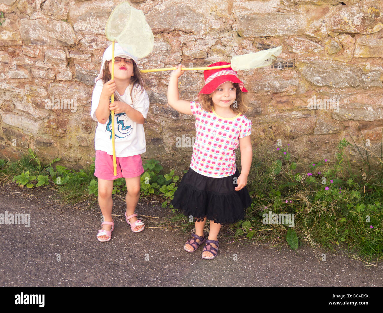 Young girls with fishing nets ready for an adventure outdoors Stock Photo