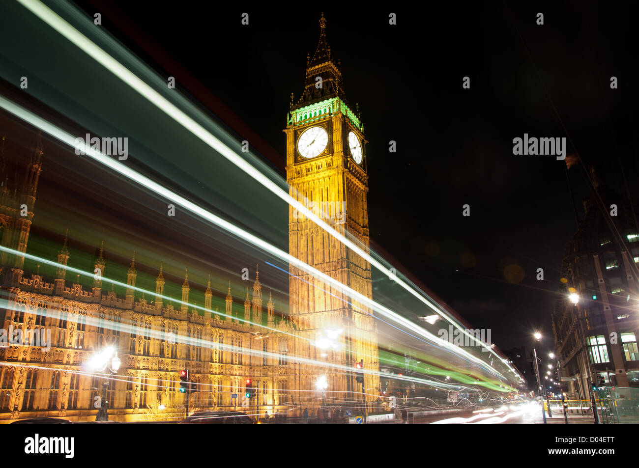 Night, slow exposure photography of Westminster Palace and Big Ben. Image has light streaks from buses in motion Stock Photo