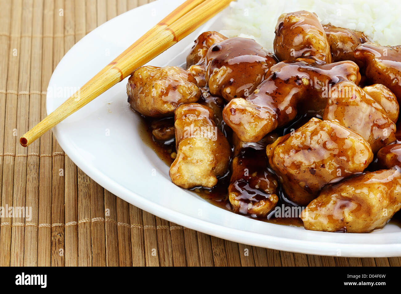 General Tso's Chicken served with white rice Stock Photo Alamy