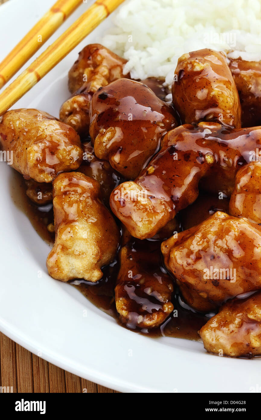 General Tso's Chicken served with white rice Stock Photo Alamy