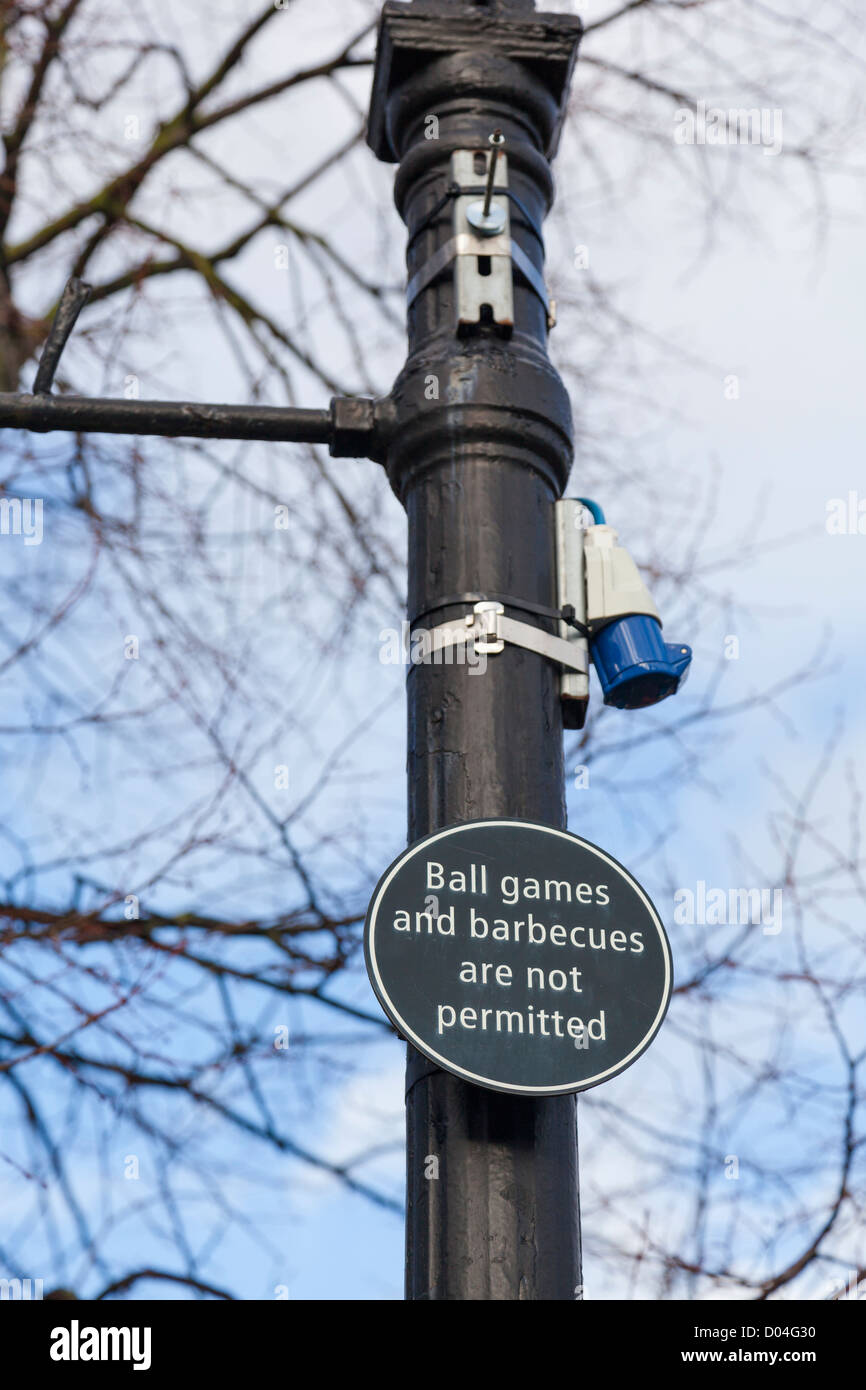 Sign on a street lamp prohibiting ball games and barbecues, England. Stock Photo