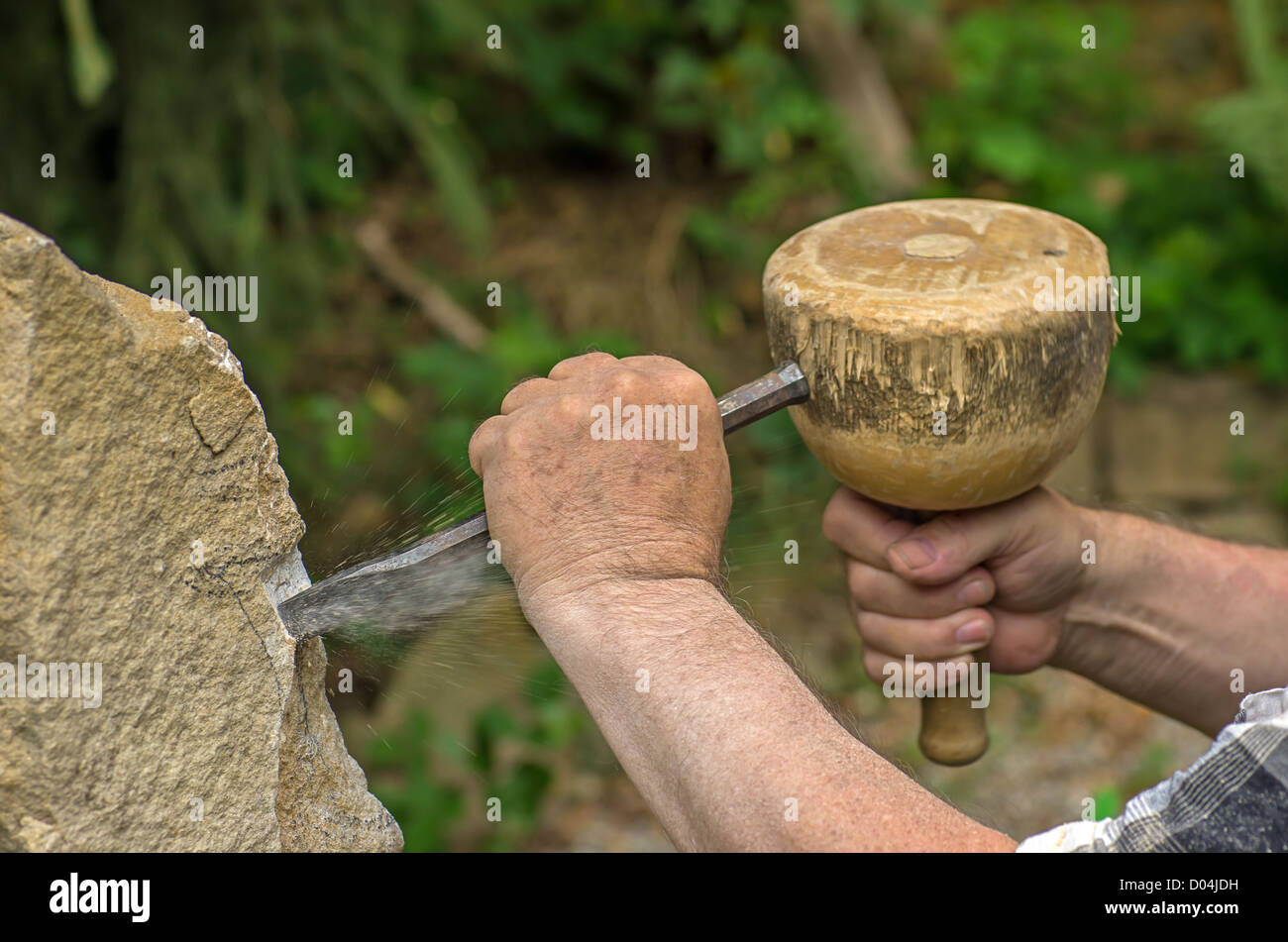 sculptor working on a stone sculpture Stock Photo