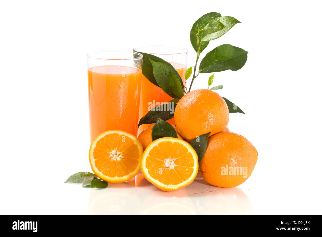 photo of fresh orange juice with water drops and green leaves Stock