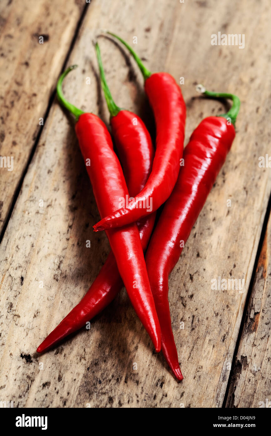 hot chili peppers on wooden desk Stock Photo