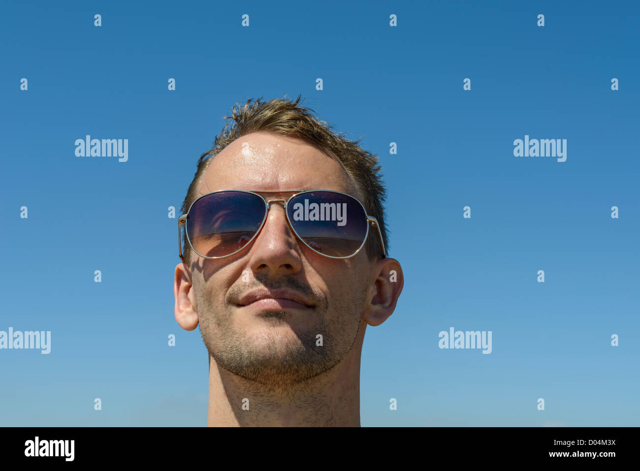 handsome young man sunglasses blue sky headshot Stock Photo - Alamy