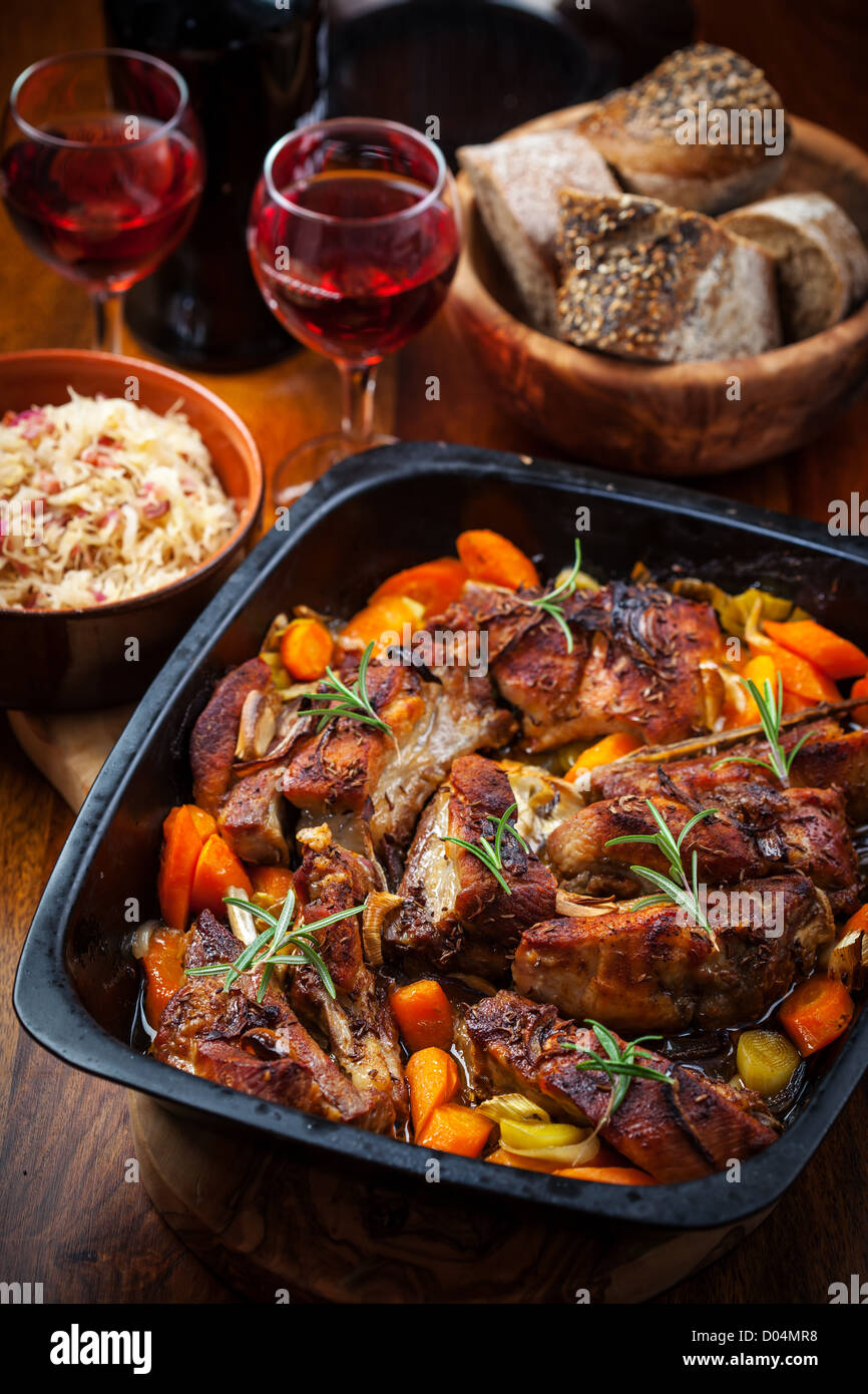 Roasted pork belly on vegetables with sauerkraut and red wine Stock