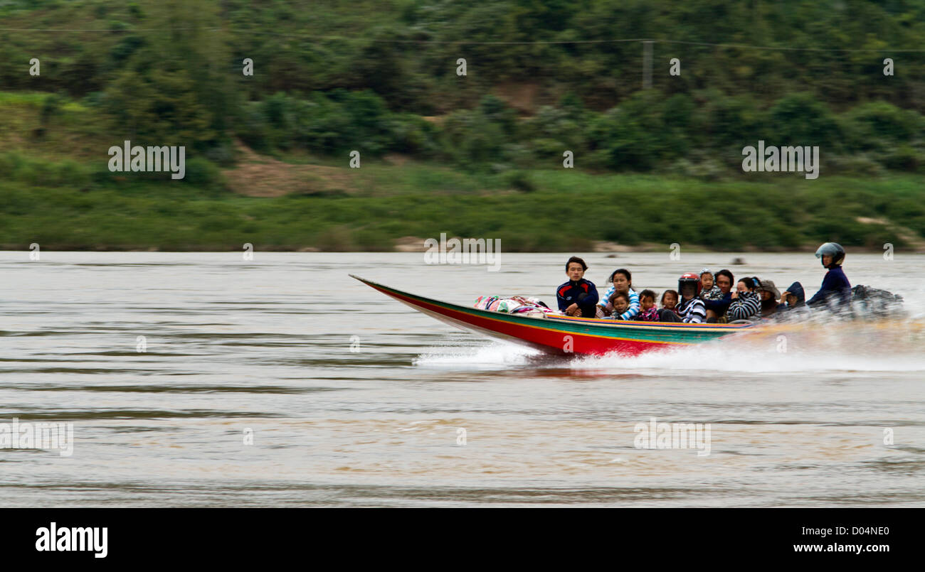 The mighty Mekong river is the major highway in Laos.  Fast boats act as river taxis. Stock Photo