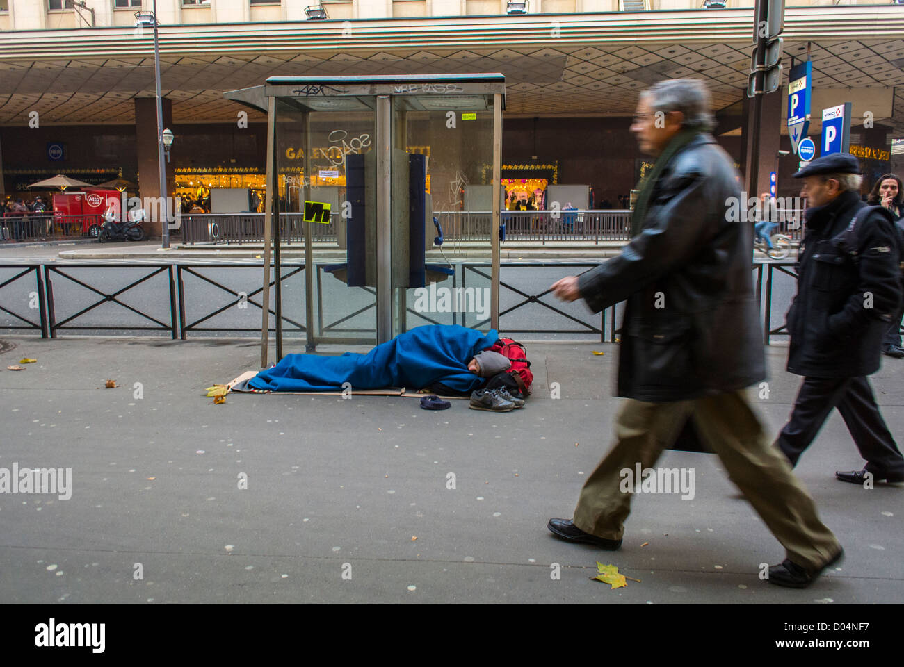 Paris, France, Homeless Man Lying on Street, Front of French Department Store, in Center CIty