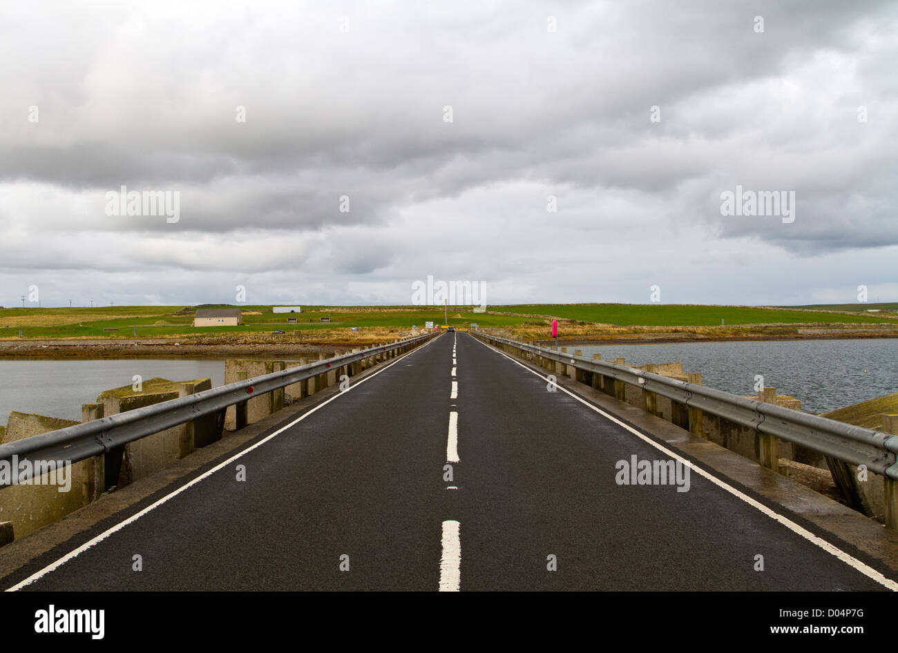 Looking along Churchill Barrier No 1 from the island of Lamb Holm to the mainland of Orkney. Stock Photo