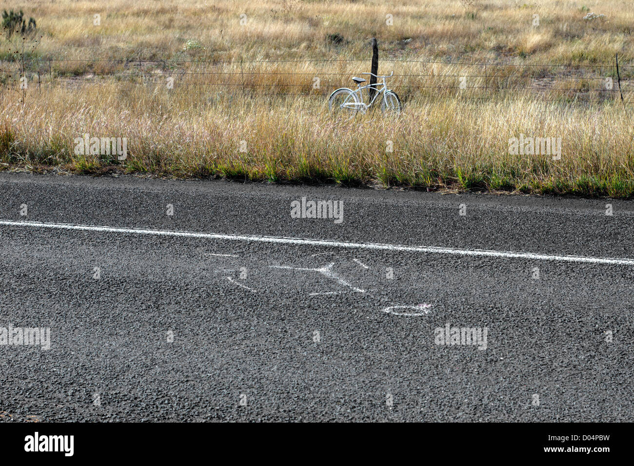 Forensic marks on a road and white bicycle called a White Ghost Bike, symbol of a cyclist death in the USA, near Marathon, Texas Stock Photo